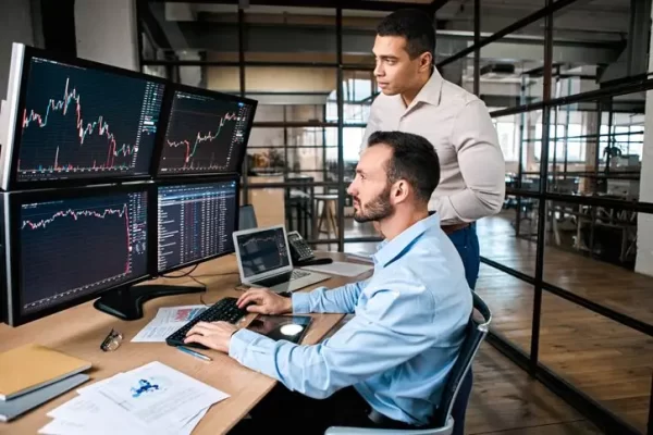 Two trader checking global currency index on fund exchange